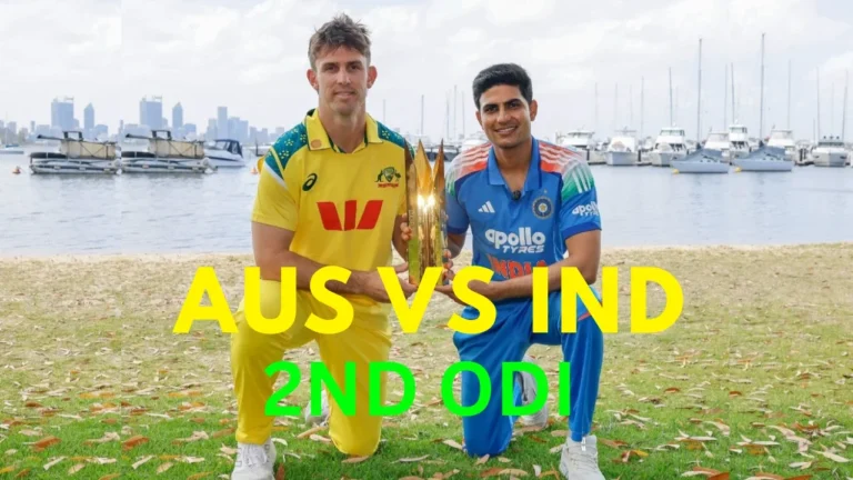 Australian captain Mitchell Marsh and Indian captain Shubman Gill posing with the ODI trophy on a grassy bank near a river or harbor with boats and a city skyline in the background, ahead of the Australia vs India 2nd ODI. The text reads "AUS VS IND 2ND ODI".
